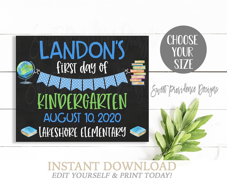 May include: A chalkboard sign with a blue and white banner, a globe, and a stack of books. The text on the sign reads "LANDON'S first day of KINDERGARTEN AUGUST 10, 2020 LAKESHORE ELEMENTARY".