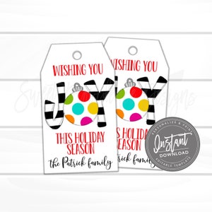 May include: Two white holiday gift tags with the words "Wishing You Joy This Holiday Season" in red and black. The word "Joy" is stylized with a colorful ornament and black and white striped letters. The tags are personalized for the Patrick family.