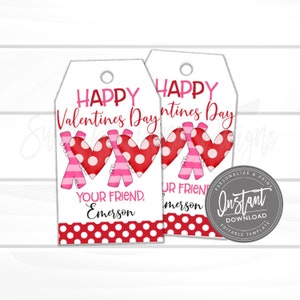 May include: Two printable Valentine's Day gift tags with red and white polka dot backgrounds. The tags feature a pink and red heart design with the text "Happy Valentines Day" and "Your Friend, Emerson".