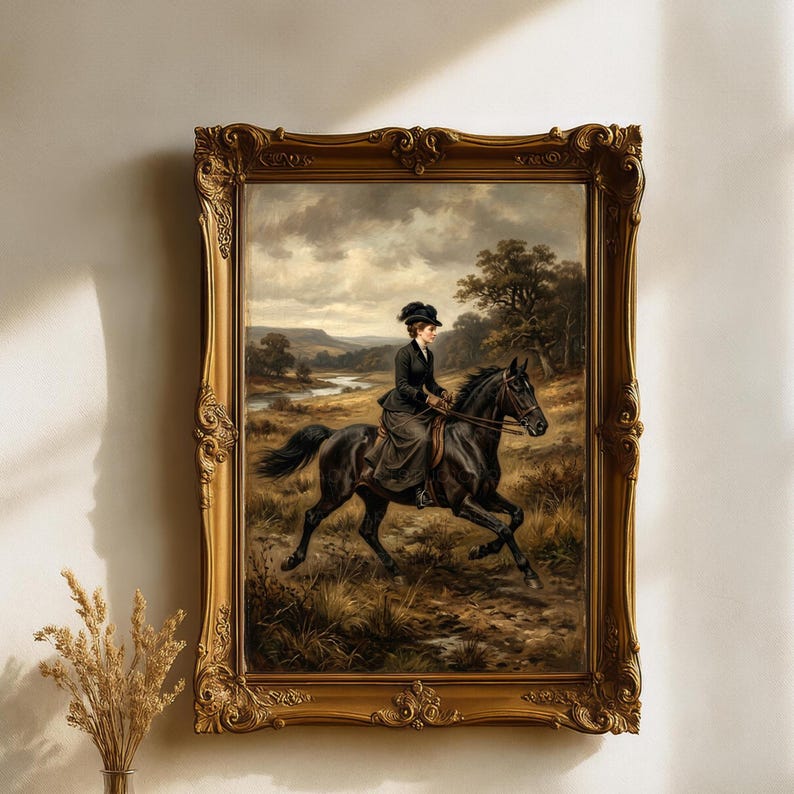 May include: An antique framed painting depicts a woman riding a black horse through a field. The artwork features a gold ornate frame and a landscape with a river and trees. The woman is wearing a dark riding outfit and hat.