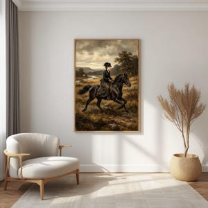 May include: A framed vintage painting depicts a woman riding a black horse across a field. The artwork features a muted color palette with a cloudy sky and a landscape in the background. The woman is wearing a dark outfit and hat.