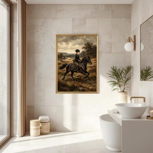 May include: A framed vintage painting depicts a person riding a black horse through a field. The artwork features a gold frame and is set against a backdrop of a cloudy sky and a river. The rider is dressed in dark clothing.