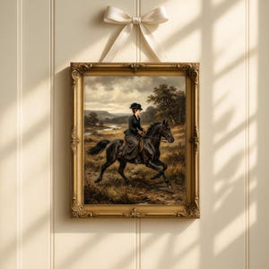 May include: A framed vintage painting of a woman riding a black horse through a field. The painting has a gold ornate frame and is suspended by a cream-colored ribbon. The artwork depicts a landscape with a river and trees.