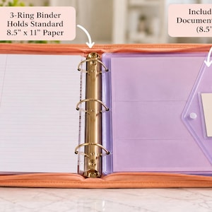 May include: A peach-colored zippered 3-ring binder containing lined white paper and clear document envelopes. The binder features a metal ring mechanism and includes text stating it holds standard 8.5" x 11" paper and includes clear document envelopes.
