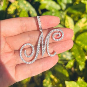 May include: A set of three ceramic mugs with a speckled, matte finish. The mugs are in shades of cream, light brown, and dark brown. Each mug has a simple, minimalist design and a rounded handle. The mugs are likely for coffee or tea.