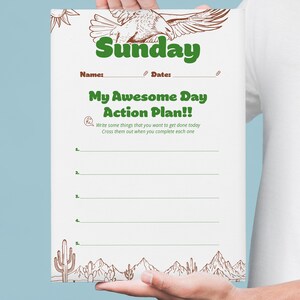 以下が含まれることがあります： 緑色の「Sunday」の文字、太陽と鳥のイラスト、そして「My Awesome Day Action Plan!!」のテキストが特徴の白い紙のプランナー。タスクを書き込むスペースと砂漠の風景のデザインが含まれています。