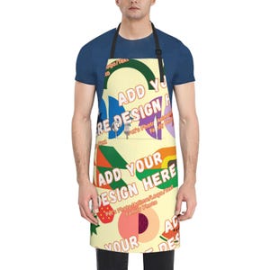 May include: Apron with a cream-colored background and a colorful design. The apron features text that reads "ADD YOUR DESIGN HERE" and "REDESIGN". The design includes various shapes and colors, including a peach, strawberry, and rainbow.
