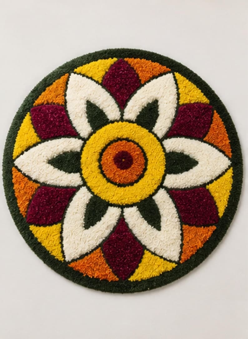 May include: A circular tufted rug featuring a symmetrical floral mandala pattern. The design consists of a central orange circle surrounded by alternating white, deep red, yellow, and orange petals, all bordered by a dark forest green outer ring.