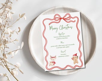 May include: A white menu card with a red ribbon border and the words "Merry Christmas" in green script. The menu lists appetizer, main course, and dessert options, including burrata, penne, and brownies. A reindeer and gingerbread man are at the bottom.