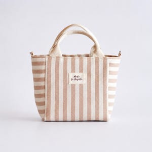 Small handmade tote bag sewing project with zipper pocket inside