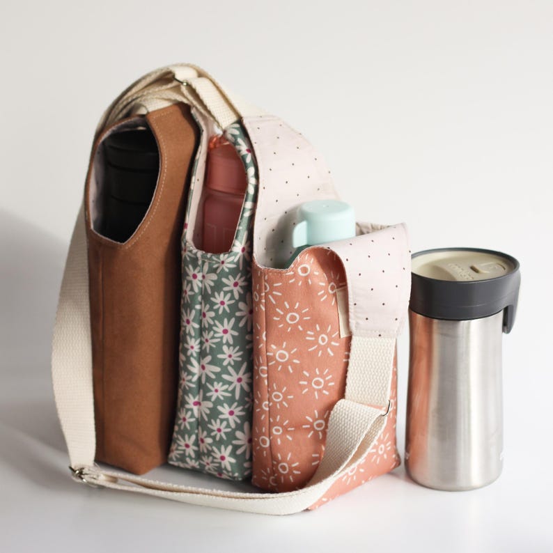 Hands-free bottle carrier sling shown on a person for hiking, walking, or festivals.