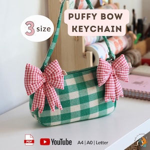 May include: A green and white checkered puffy bow keychain with two red and white gingham bows. The keychain has a green handle and the text "PUFFY BOW KEYCHAIN" is displayed. The image also shows "3 size" and YouTube and PDF icons.