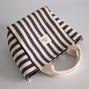 Mini tote bag sewing pattern featuring handles, lining, and zipper pocket
