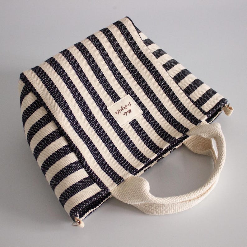 Mini tote bag sewing pattern featuring handles, lining, and zipper pocket