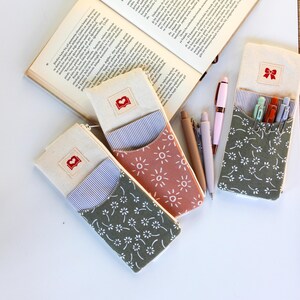 Elastic pencil pouch attached to planner notebook