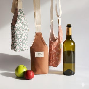 Rust-colored canvas wine bag with a minimalist woven label and polka dot interior lining.