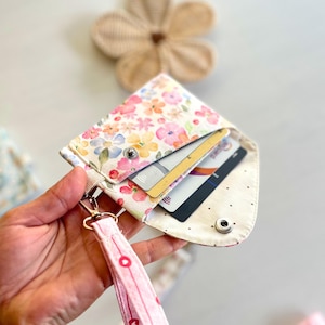 Compact card holder with snap button and metal keyring hardware.