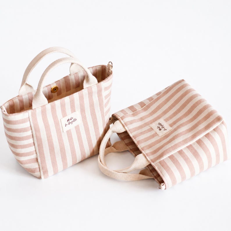 Tote bag with zipper pocket, short handles, and long shoulder strap