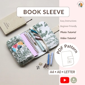 May include: A fabric book sleeve with a green and white toile pattern, containing a spiral notebook, pens, and clips. The image includes text reading BOOK SLEEVE, Easy Instructions, Beginner Friendly, Photo Tutorial, Video Tutorial, and PDF Pattern.