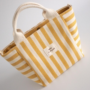 Small fabric tote bag with crossbody strap and practical inner pocket