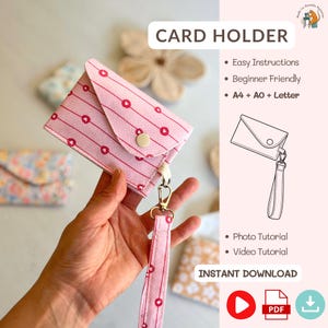 May include: A pink card holder with a heart and stripe pattern, a wrist strap, and a gold-colored clasp. The text "CARD HOLDER" is at the top. The image also includes the text "Easy Instructions", "Beginner Friendly", "A4 + AO + Letter", "Photo Tutorial", "Video Tutorial", and "INSTANT DOWNLOAD".