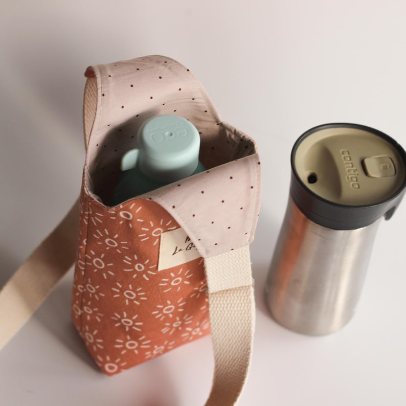 Close-up of a sewing project showing professional stitching and inner lining of a bottle bag.