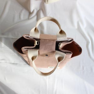 Trio of handmade canvas bags in sage green and terracotta pink, showcasing the versatile tote bag pattern.