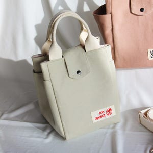 Purse sewing pattern for a boxy-shaped lunch carrier with multiple exterior pockets.