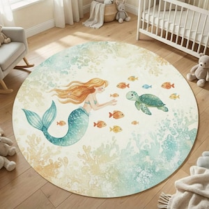 May include: A circular rug with a watercolour design of a mermaid with flowing red hair and a teal tail, swimming with a sea turtle and several orange and yellow fish. The rug has a light blue and beige background.