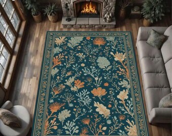 May include: A rectangular area rug with a dark teal background and a floral pattern in orange, cream, and white. The rug has a decorative border and is placed in a living room setting with a fireplace and sofa.