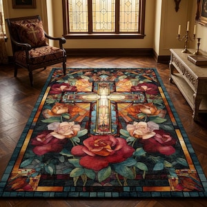 May include: A rectangular rug featuring a stained-glass cross design, encircled by roses in red, orange, and cream hues. The rug has a dark blue border and is placed on a wooden floor.
