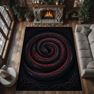 May include: A black rug with a coiled snake design, featuring red and gold detailing. The snake's body is spiralled, creating a striking visual effect. The rug has a decorative border and is placed on a wooden floor.