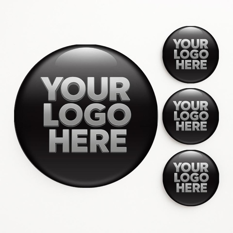 May include: Black glossy round buttons with the text "YOUR LOGO HERE" in silver. The image shows a large button and three smaller buttons, all with the same design. The buttons have a reflective surface.