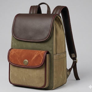 Peut inclure: Un sac &agrave; dos dot&eacute; d'un rabat sup&eacute;rieur en cuir grain&eacute; marron fonc&eacute;, d'un corps en toile vert olive et d'une poche avant avec un rabat en daim couleur rouille, ferm&eacute; par un bouton en laiton. Le sac poss&egrave;de des bretelles r&eacute;glables et des bordures.