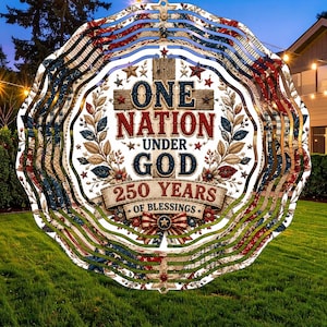 May include: A patriotic, layered metal garden spinner with a design featuring the text "ONE NATION UNDER GOD" and "250 YEARS OF BLESSINGS." The design incorporates stars, stripes, and floral elements in red, white, and blue.