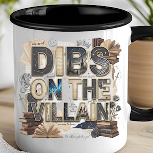May include: White ceramic mug with a black interior and handle, featuring the text "DIBS ON THE VILLAIN" in a layered design with book and fantasy elements. The mug has a glossy finish and is suitable for hot or cold beverages.