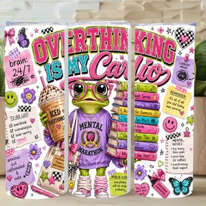 May include: A cylindrical tumbler featuring a graphic of a green frog wearing pink glasses and a purple sweatshirt. The design includes the text OVERTHINKING IS MY CARDIO, an iced coffee, stacks of books, sticky notes, and colourful butterfly icons.