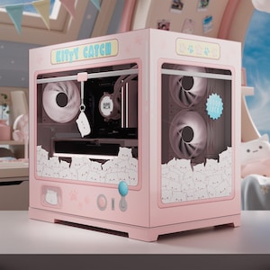 May include: A pink computer case with a claw machine design, featuring the text "KITTY CATCH". The case has clear panels revealing internal components and fans. Decorated with cat illustrations and paw prints, it includes a blue joystick and a "GOOD LUCK" sticker.