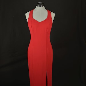 May include: A red sleeveless maxi dress with a sweetheart neckline and a slit up the front.