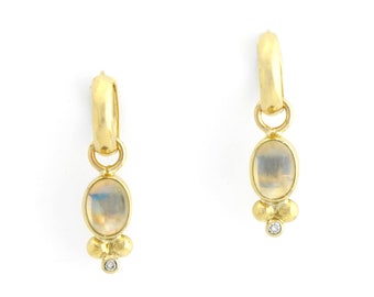 May include: A pair of gold hoop earrings with a dangling oval moonstone and a small diamond accent.