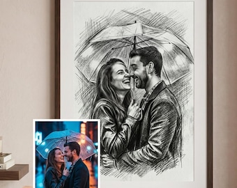 May include: A framed black and white sketch of a couple under an umbrella, with a smaller color photo of the same couple held in a hand. The sketch is detailed, capturing the couple's expressions. The background is a neutral wall with a small shelf.