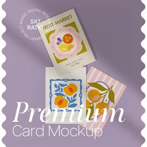 May include: A mockup featuring three 5x7 cards with fruit-themed illustrations. One card displays a floral design with a fruit arrangement, another showcases peaches, and the third has oranges on a striped background. The words "FRUIT MARKET" and "Premium Card Mockup" are visible.
