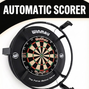 May include: Black dartboard with the text "AUTOMATIC SCORER" at the top. The dartboard has a black frame and a classic target design with red, green, and tan sections. The brand "WINMAU" is visible.