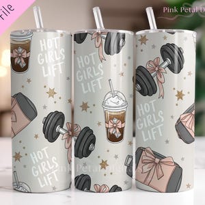 May include: Three stainless steel tumblers with a light grey background. The tumblers have a repeating pattern of dumbbells, coffee drinks, and gym bags, with pink bows and gold stars. The text "HOT GIRLS LIFT" is also displayed on the tumblers.