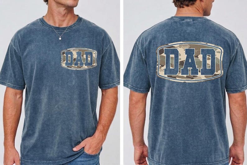 May include: A blue short-sleeved t-shirt with the word "DAD" in a camouflage design on the front and back. The shirt has a vintage, washed look.
