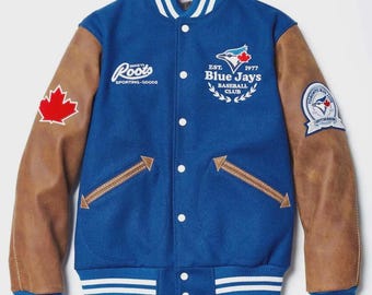 Chaqueta universitaria Roots de los Toronto Blue Jays: lana azul rey y mangas de cuero marrón