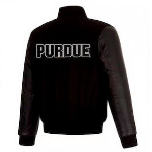 May include: Black varsity jacket featuring the word "PURDUE" in white block letters on the back. The jacket has black leather sleeves and a black body. The collar and cuffs are ribbed.