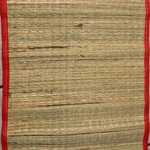 May include: A white ceramic mug with a black handle and the text "But First, Coffee" in a bold, black font. The mug is set against a blurred background, suggesting a cozy setting.