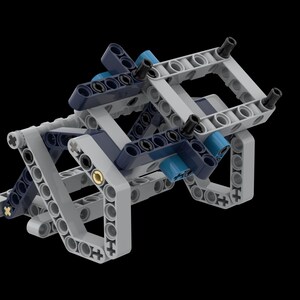 Peut inclure: Structure complexe faite de pièces en plastique emboîtables dans des tons de gris, bleu marine et bleu clair. La construction semble être un modèle ou un composant d'une construction plus grande, avec divers points de connexion et formes géométriques.