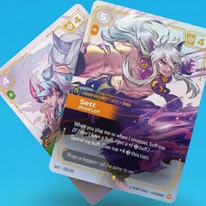 May include: Two trading cards featuring fantasy art. One card displays a character with white hair and purple accents, labeled "Sett Brawler." The other card shows a character with blue and pink tones. Both cards have game-related text.